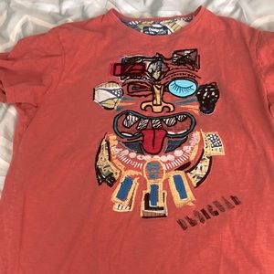 orange tee shirt with funky design face